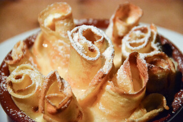 closeup of gratinated pancakes with sugar topping in vanillia sause