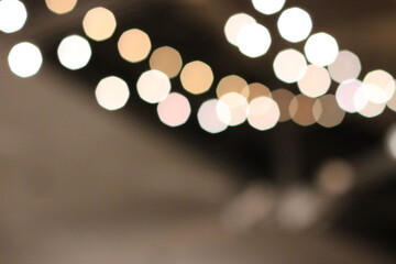 String of white, beige and orange bokeh circles