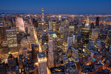 Aerial evening view of Midtown New York City skyline along Fifth Avenue. Illuminated Manhattan skyscrapers, NYC. USA