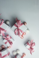 Obraz na płótnie Canvas White gifts with pink ribbons. Set of gift box isolated on white background.Christmas gift boxes on white background. Beautiful Christmas background with shiny balls and ribbons in pastel pink color. 