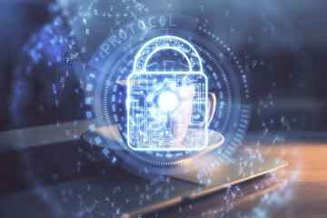 Obraz premium Double exposure of desktop with computer and lock icon hologram. Concept of data safety.