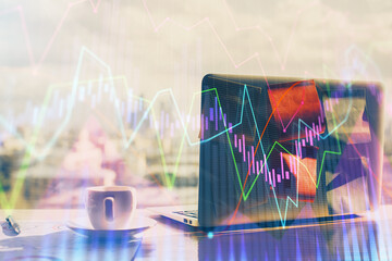 Financial chart drawing and table with computer on background. Double exposure. Concept of...