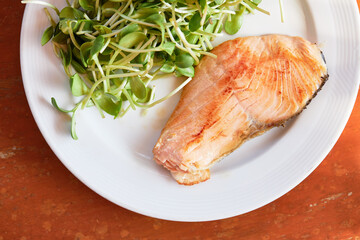 Salmon steak with sunflower sprout