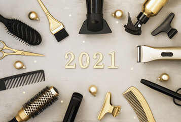 New year banner with hairdressing tools and figures 2021. Gold and black hair salon items on a gray...