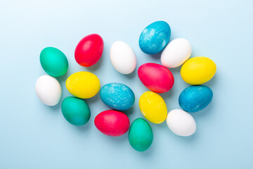 Top vew of multicolored easter eggs on blue background. Easter concept. Copy space
