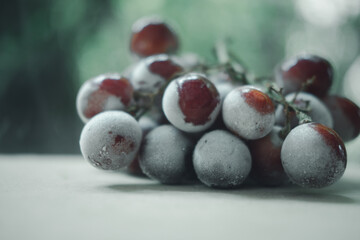 Frozen red grapes on wooden
