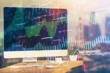 Stock market chart on background with desk and personal computer. Multi exposure. Concept of financial analysis.