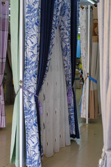Displayed colorful curtain samples in the shop.