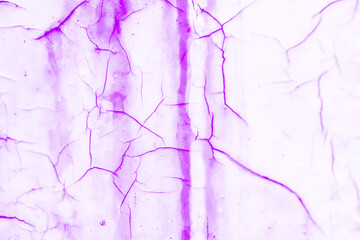 Purple and white cracked textured plaster wall