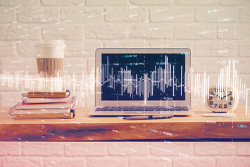 Financial chart drawing and table with computer on background. Multi exposure. Concept of...
