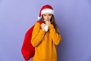 Lithianian woman with christmas hat isolated on purple background thinking
