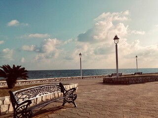 Promenade along the Mediterranean with benches and lampposts