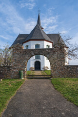 View through the gate in the wall to the Kreuzkapelle in Bad Camberg / Germany in wonderful autumn weather