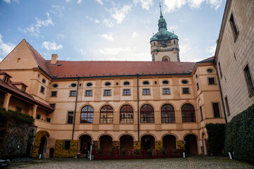 Obraz premium Medieval castle Melnik in sunny autumn day, Courtyard with Renaissance arcades, High clock tower of the Church of Saints Peter and Paul, Central Bohemia, Czech republic