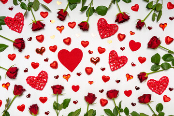 Fototapeta na wymiar Creative composition made of fresh red roses flowers, hearts and sweets on white background. Beautiful arrangement, greeting card. Love, romance or Valentine's day concept. Flat lay, top view