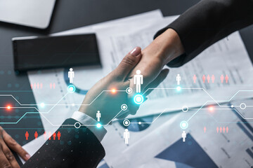 Double exposure of two businesspeople handshake and social media network icon hologram drawing background. Concept of internet connection information data. Formal wear.