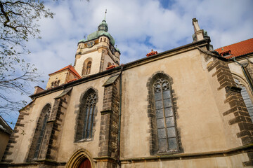 Picturesque landscape with medieval gothic catholic church of Saints Peter and Paul near castle...