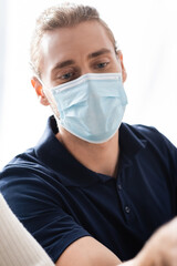 portrait of young businessman in medical mask in office