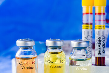 Corona virus and Covid - 19 new vaccine in ampules and blood tube, variations of vaccine