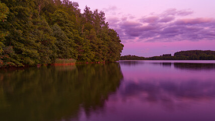 Calm lake with the purple evening sky reflecting.