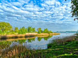 Spring landscape of a Pogoria Lake in Dabrowa Gornicza. Cloudy sky.
