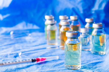 Corona virus and Covid - 19 new vaccine in ampules, different color variations of vaccine