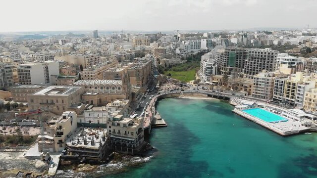 4k Aerial drone footage panning to show the cityscape of Sliema, Malta, an island town in the Mediterranean Sea.