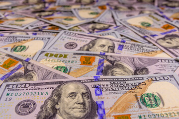 Background of one hundred dollar banknotes. Selective focus