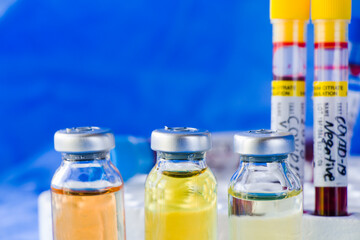 Corona virus and Covid - 19 new vaccine in ampules and blood tube, variations of vaccine