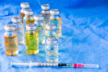 Corona virus and Covid - 19 new vaccine in ampules, different color variations of vaccine
