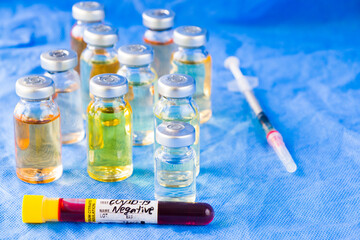 Corona virus and Covid - 19 new vaccine in ampules and blood tube, variations of vaccine