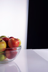 set of different varieties of apples in a transparent glass container. On a black and white background