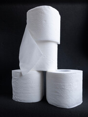 toilet paper roll on a dark background, hygiene items, essential goods during quarantine