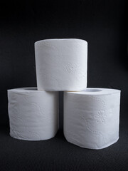 toilet paper roll on a dark background, hygiene items, essential goods during quarantine