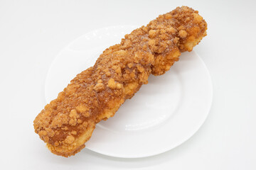 Long Fried Doughnut on a White Plate