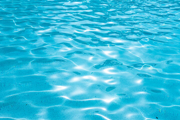 Fototapeta na wymiar Swimming pool texture and surface water on pool. Green water in the pool with sun reflection background.