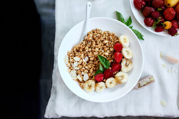 Healthy breakfast bowl, fresh granola, muesli with berries strawberry, banana