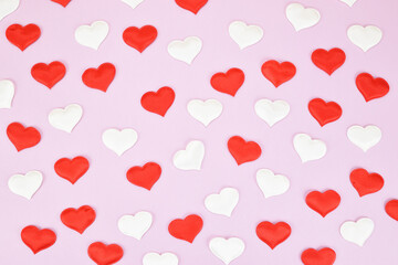 Festive pattern of red and white decorative hearts on a pink background. Valentine's day concept.