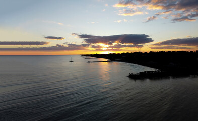 View of the city by the sea at sunset. Aerial view shot.