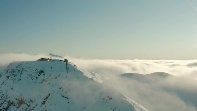 Roza Khutor Ski Resort on Snowy High Altitude Mountain peak. Aerial