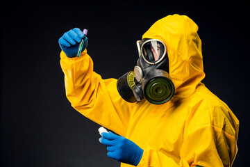 A male doctor or biologist wearing a protective suit to fight a pandemic or coronavirus. She's...