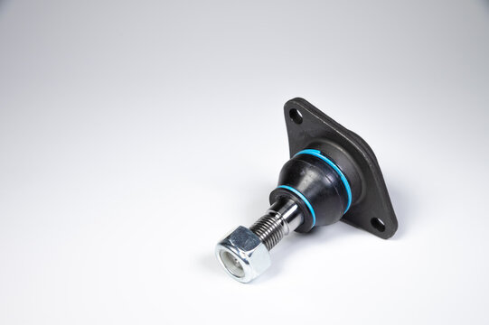 Ball joint car suspension on a gray background. New spare parts axel car elements