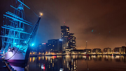 Gdynia, Poland - November 14, 2020: Polish sailing ship SV Dar Pomorza by night at the waterfront in Gdynia, Poland