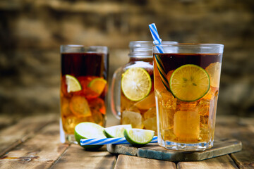 iced tea cocktail with strong drinks, wood background
