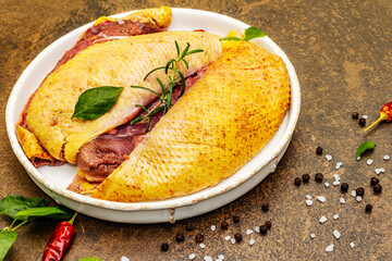 Raw duck breasts with fresh greens and fragrant spices