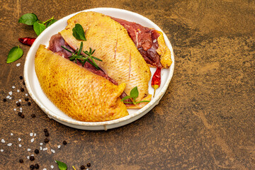 Raw duck breasts with fresh greens and fragrant spices