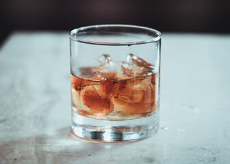 A glass of rum on the rocks.