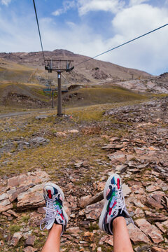 Sierra Nevada, Spain - July 18, 2017: A picture of someone's shoes while riding the ski lifts of Sierra Nevada.