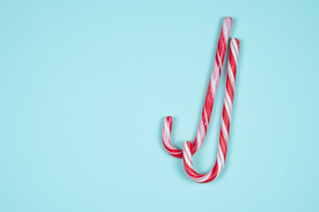 Christmas candy canes on a light blue background