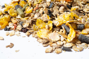 heap of natural   basic muesli  for sportive horse with corn flakes at white background. nutrient equestrian concept. close up